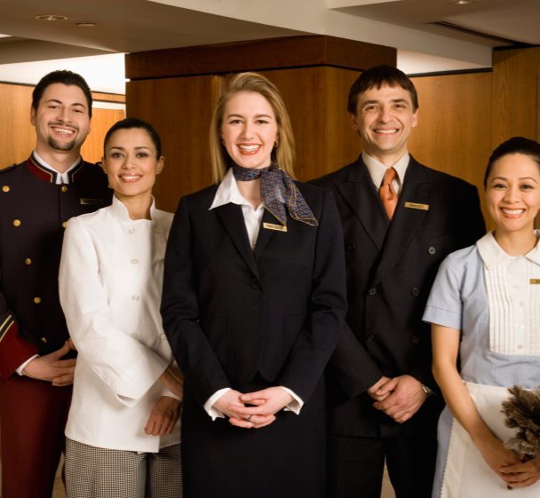 Hospitality staff in uniform, smiling