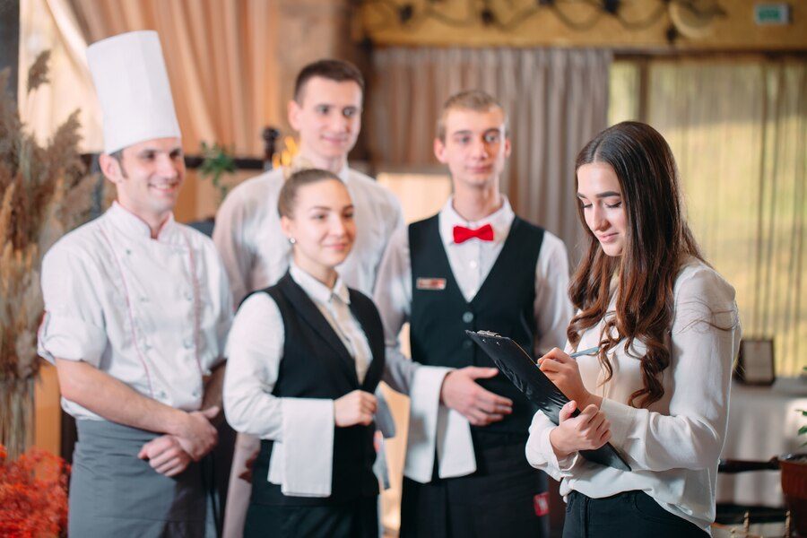Chef, waiters and bar staff together in a restaurant